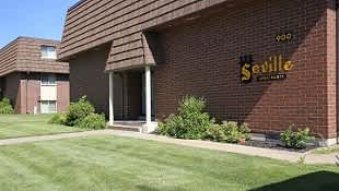 A building with a sign that says Seville on it.