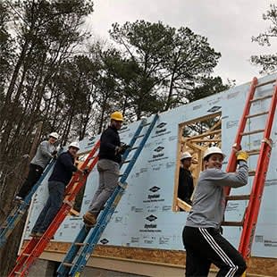 a group of men working on the roof of a building