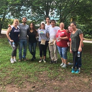 a group of people posing for a picture in the grass
