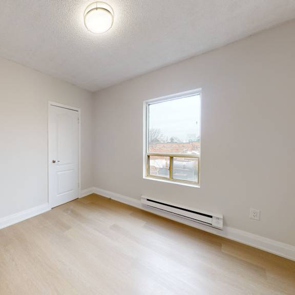 A dining room with a white table and chairs.