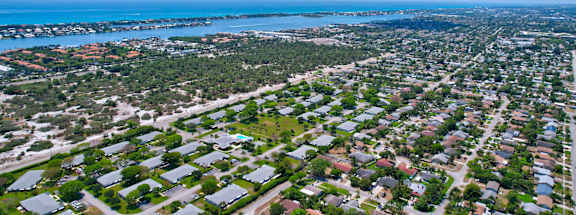 a high aerial view of Boynton Beach. there are houses,  trees, and the ocean