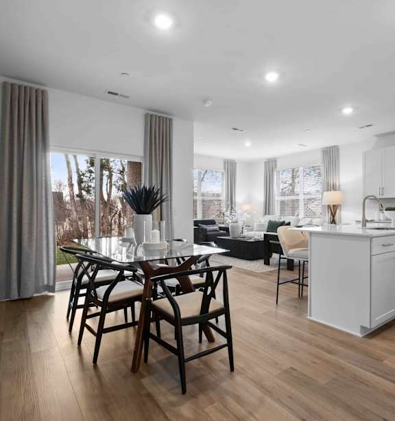 A modern kitchen with a dining table and chairs.