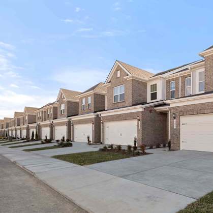 A row of houses with garages in front.