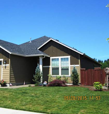 A house with a garage and a flag in front.