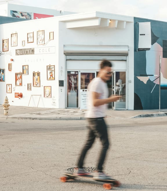 a man riding a skateboard down a city street