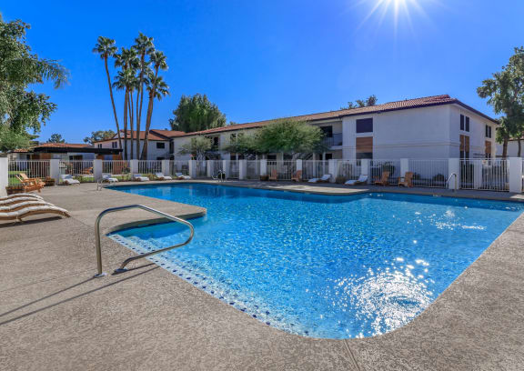 a patio with a grill and a swimming pool