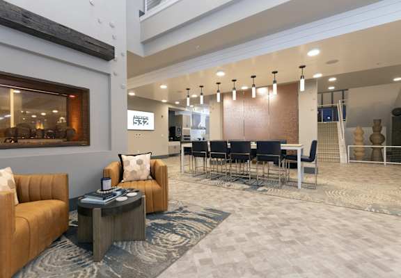 a large lobby with couches and chairs and a table with chairs at Anchor 532 Luxury Apartments, Vallejo, CA 94590