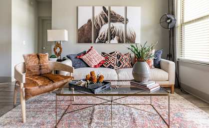 a living room filled with furniture and a large window