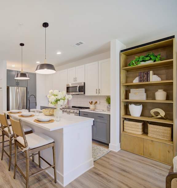 A modern kitchen with a dining table and chairs.
