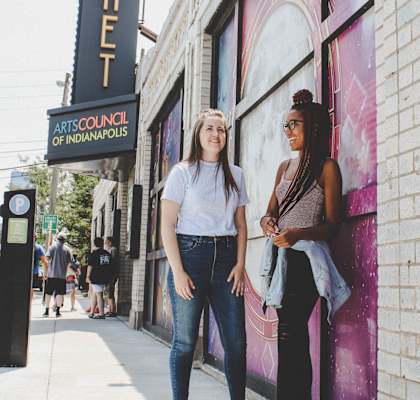 Friends standing outside near The Ambassador at Library Square, IN, 46204