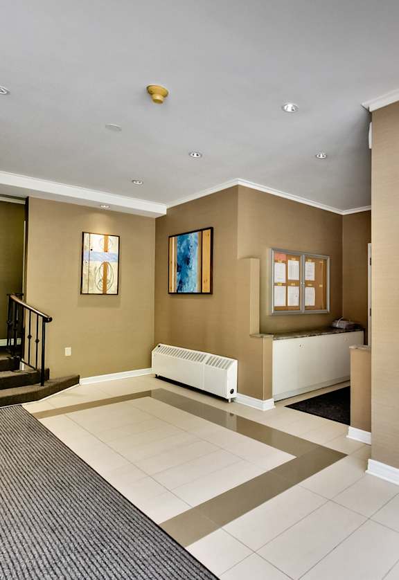 a view of a lobby with a baby crib and a glass door