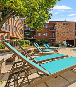 a group of lounge chairs and tables on a patio