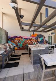 A modern kitchen and dining area with a view of the city.