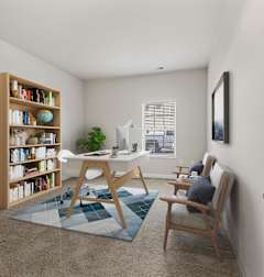 a home office with a desk and a bookshelf