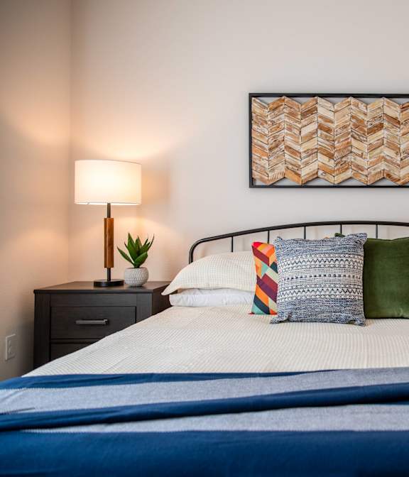 a bedroom with a bed and two night stands with lamps