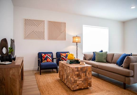 a living room filled with furniture and a large window
