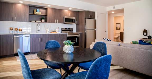 a living room and kitchen with a table and chairs at Scouter's Mountain, Happy Valley