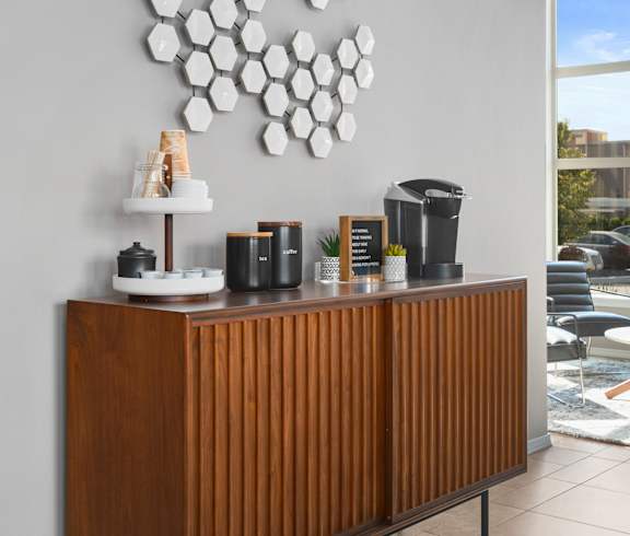 a coffee counter with coffee pots and a plate rack on top of it at Mosaic on the River Apartments, Richland