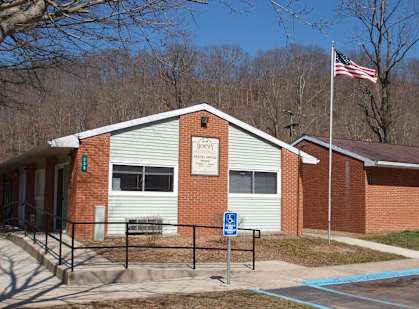a brick school building with an flag in front of it