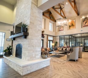 a large lobby with couches and chairs and a fireplace