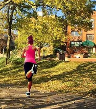 a woman is running in a park