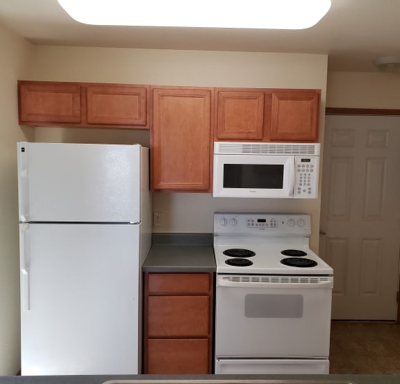 Image of refrigerator, stove, microwave, and cabinets