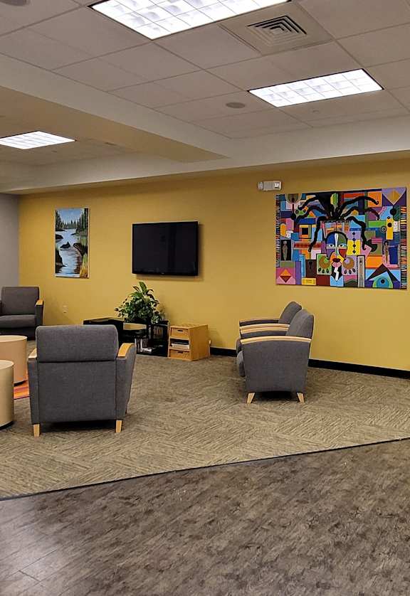 the lobby of a building with couches and chairs