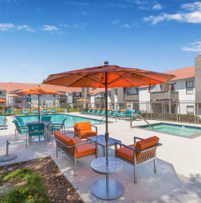 our apartments have a large patio with chairs and umbrellas