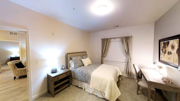 a bedroom with a bed and a desk