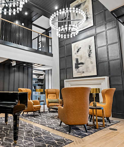 a piano and chairs in the lobby of a building
