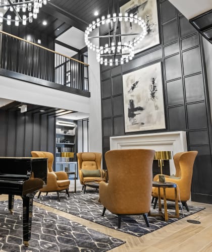 a piano and chairs in the lobby of a building