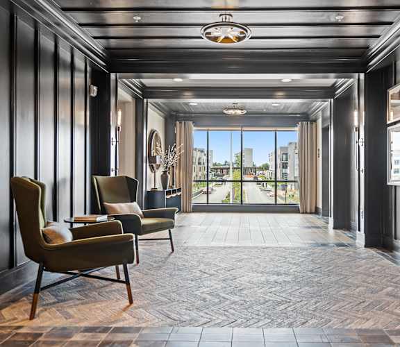 a hallway with black walls and a large glass door with a view of the city