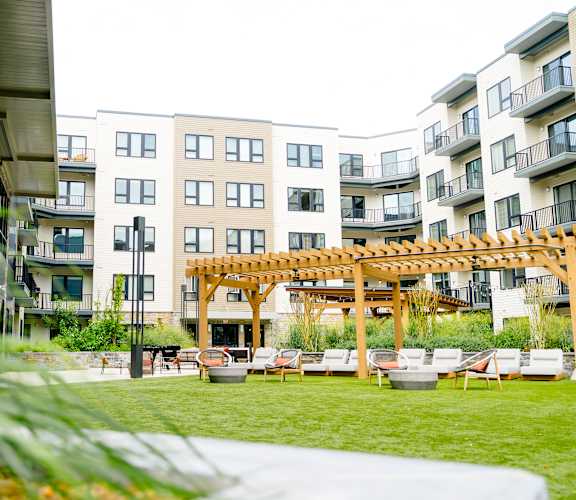 an apartment complex with a patio and a pergola