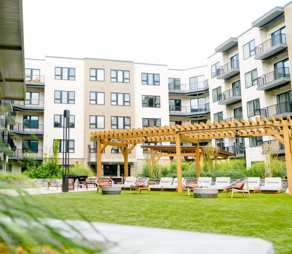 an apartment complex with a patio and a pergola