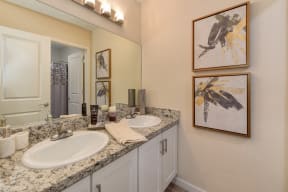 Bathroom with Granite Countertops, Vanity and Framed Abstract Paintings