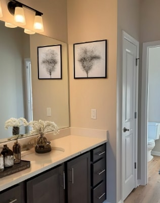 A bathroom with a white towel hanging on a counter.