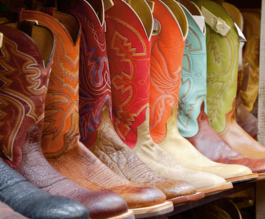 a row of cowboy boots on display in a store at The Lodge at Lakeline Village, Texas, 78613