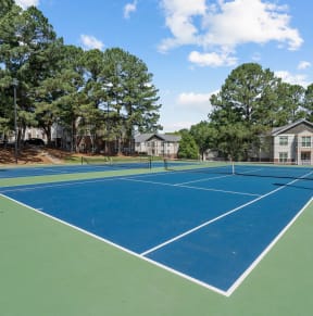 the tennis courts at the whispering winds apartments in pearland