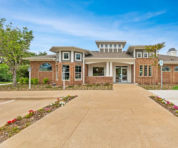 the front of a brick house with a driveway and a drive way at Sandy Creek Apartments, Bryan, Texas