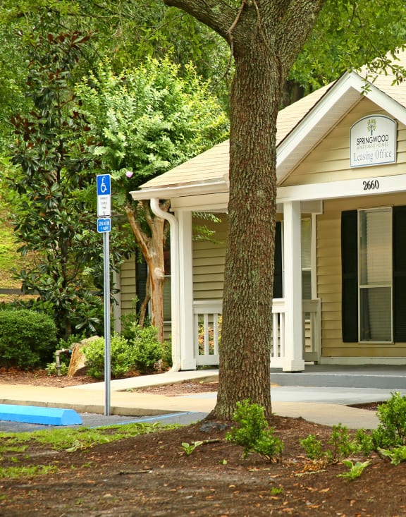 the front of a house with two trees in front of it