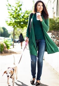 a woman walking her dog while holding a cup of coffee at Madison Hunters Glen, NC 27606
