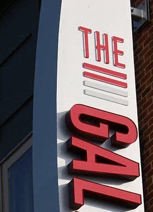 a red and white sign on the side of a building