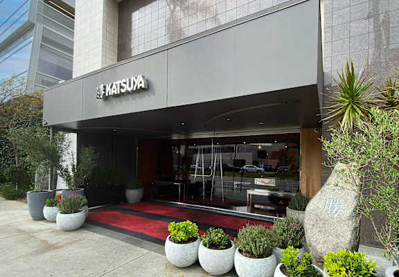 The front of a building with a sign that says Katsuya.