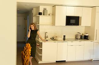 Woman in kitchen at Scout Living, powered by Placemakr, Atlanta, 30308