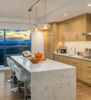 a kitchen with a white marble counter top and a large window at Two Lincoln Tower Apartments, Bellevue, WA, 98004