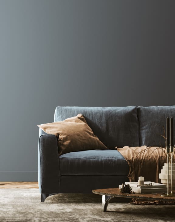 a living room with a blue couch and a coffee table