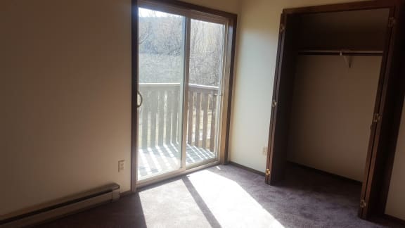 An image of a sliding glass doo and a deck beyond that door