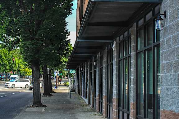A modern building with a parking lot in front of it.
