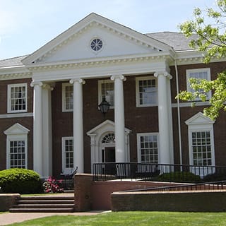 a large brick building with white pillars and a gray roof at The Terminal Tower Residences Apartments, Ohio, 44113