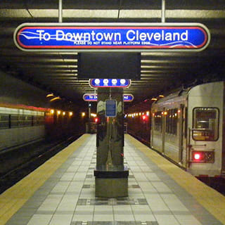 a subway station with a train and a sign that says to downtown cleveland at The Terminal Tower Residences Apartments, Ohio, 44113